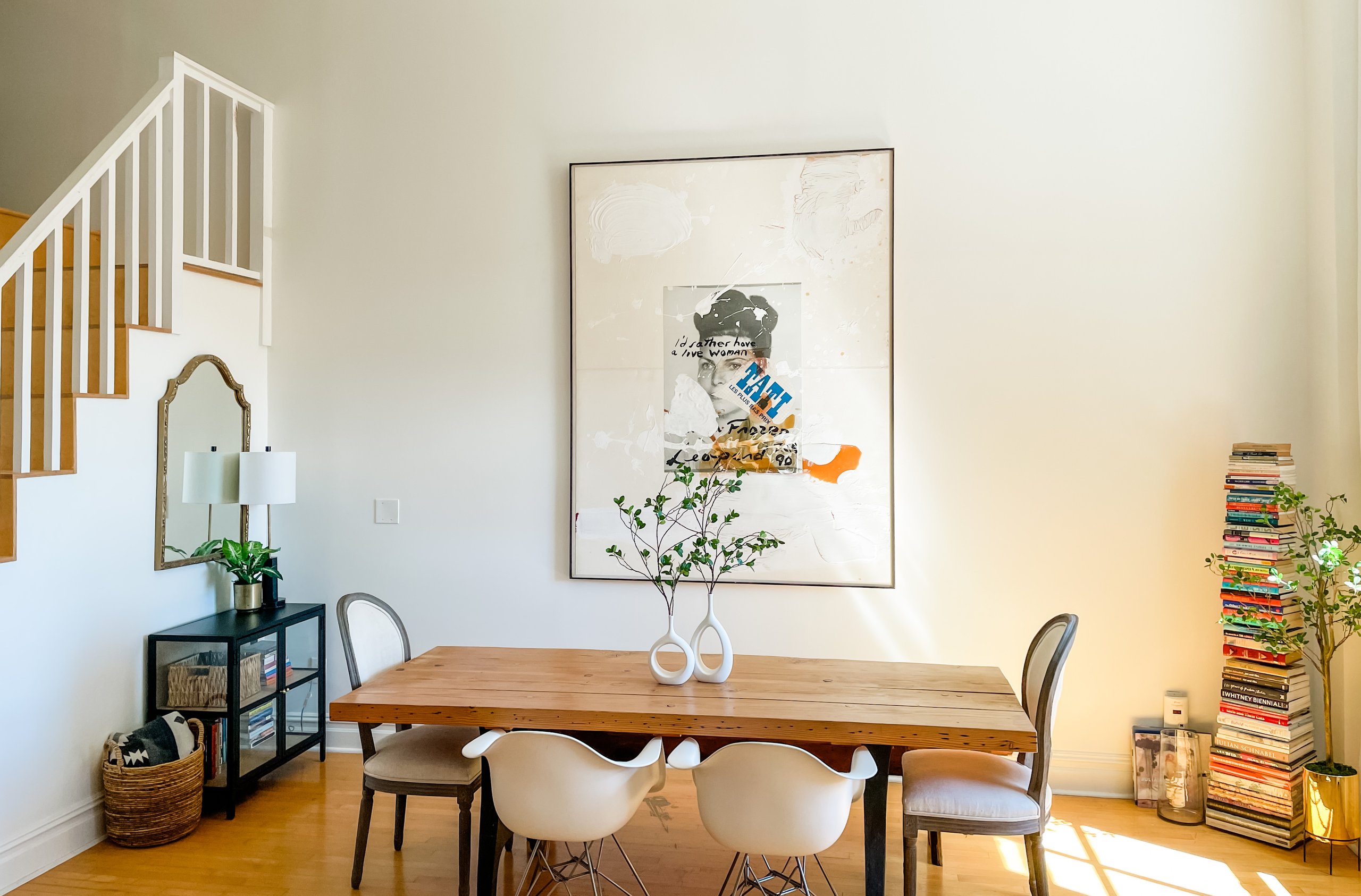 Dining room with staircase and artwork