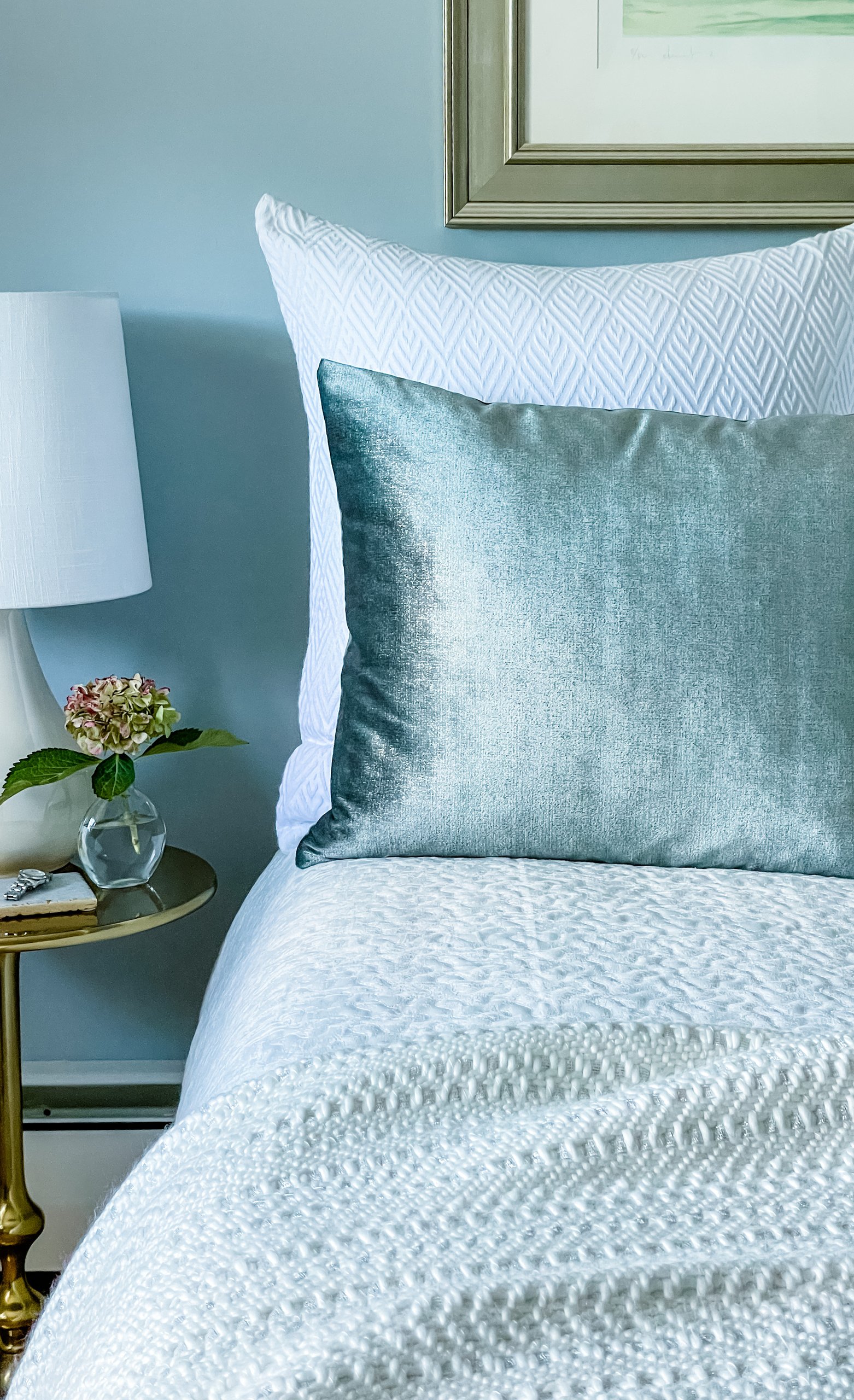 Bedroom detail with blue velvet pillow